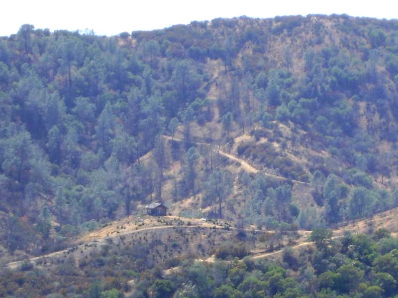 I spot an interesting feature: a little cabin, probably privately owned, on the other side of the canyon