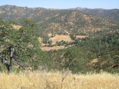 I stop at the first summit on the trail and take in the views of the ranch below and the quiet hills