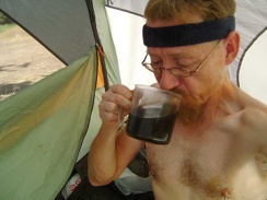 Drinking hot morning coffee in the hot morning tent