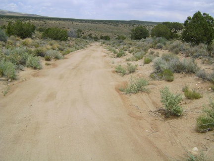 I ride down into Watson Wash on the short segment of the old Mojave Road near the Bert Smith Rock House