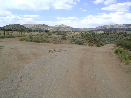 The main New York Mountains Road continues to the right