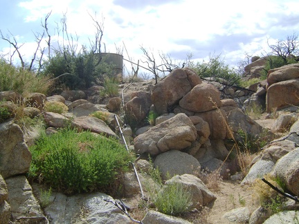 Howe Spring wash is dry, but I discover some piping that leads up to a water tank