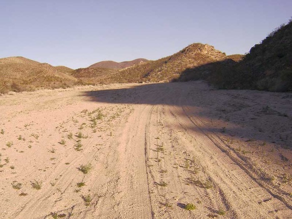After about three miles, Indian Springs Road turns toward the hills up a sandy wash