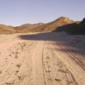 After about three miles, Indian Springs Road turns toward the hills up a sandy wash