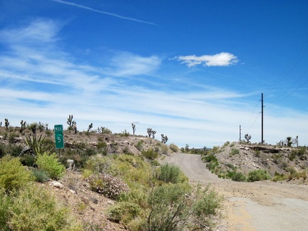 I pass the shot-up 5-mile marker on Walking Box Ranch Road