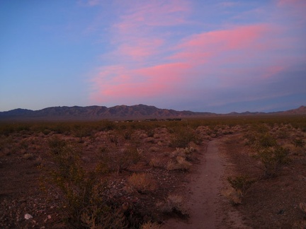 It's getting darker (and redder) by the minute as I follow a small drainage in the creosote-bush scrub on the way back to Nipton