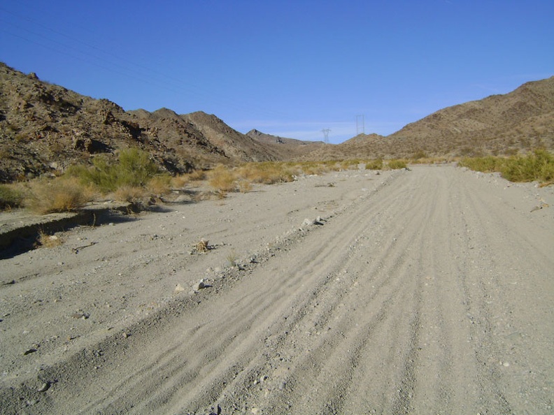 The faded paved track to the left is rather washed-out and grown-in, so I abandon it and return to the gravel of Jackass Canyon