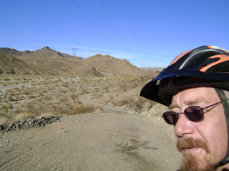 At the top of my little hill, I now get to ride back down the old paved road and return to the gravel of Jackass Canyon