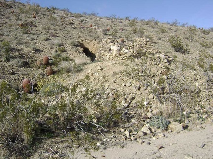 Near those crumbling rock walls is a hole in the hillside