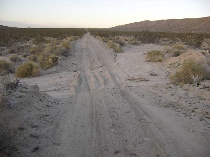 Bigger sandy drainages cross Jackass Canyon Road on the way down