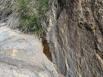 A miniscule pool of water holds out between some rocks on &quot;Indian Spring Plateau&quot;