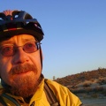 I catch the red rays of sunset as I pedal down Kelbaker Road toward Baker