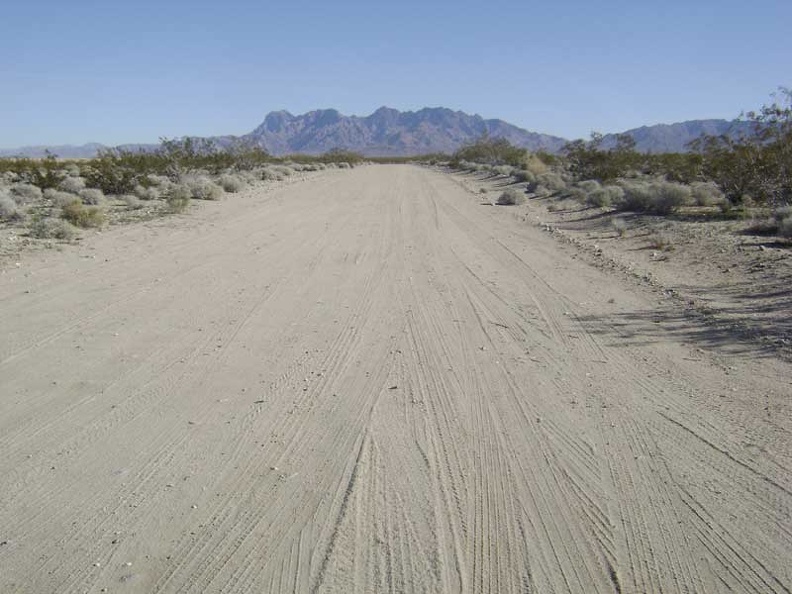 I ride away from the campsite up Kelso Dunes Road toward the Providence Mountains