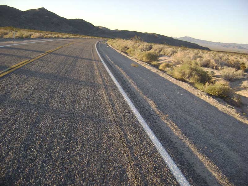 About eight miles down from the summit, I fly around the curve near the Kelbaker Road lava flows