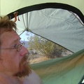 It's a hot morning, probably in the high 70s; I mount the rain cover on the sunny side of the tent to get some shade