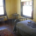 A couple of the small sleeping rooms are furnished in the simple style of the period