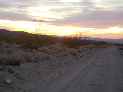 Sunset on the Kelso Dunes power-line road is nice, and the road starts out being OK for riding