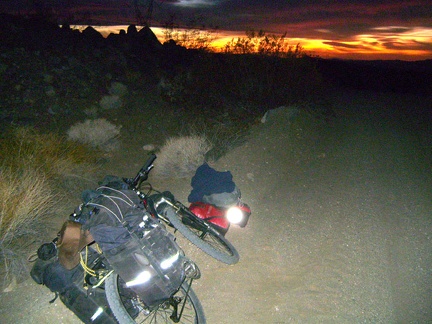 Success! I found one flat, wide-enough, non-rocky spot above the road, so I'm back at the bike to dismantle it and set up camp