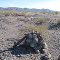 Out here &quot;in the middle of nowhere&quot; in the Kelso Dunes Wilderness Area is a rock cairn with something attached to it