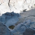 From my perch near the top of the dry waterfall, I look down at the tiny pool of water remaining amongst the rocks