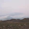 A few clouds are rolling in east of the Bristol Mountains at dusk