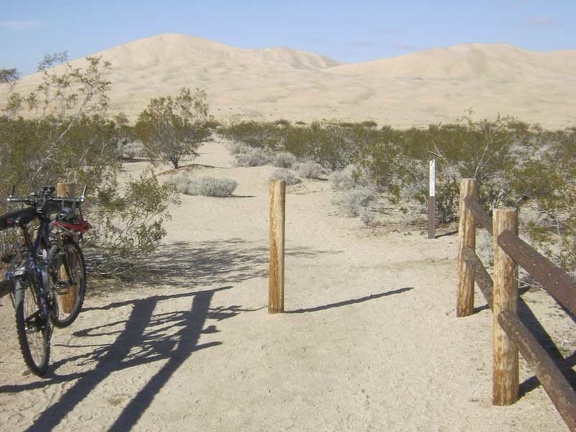 I lock the bike to the fence at the Kelso Dunes trailhead