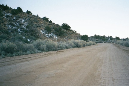 Patches of light snow survive from last night on the north side of hills facing Cedar Canyon Road in the Mid Hills