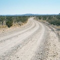 I ride down the almost imperceptible slope of Ivanpah Road toward Cedar Canyon Road