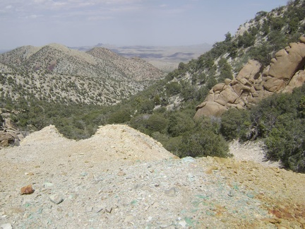 Teal-blue rocks are scattered around the mine site while "Sleeping-head Rock" keeps watch from the right side