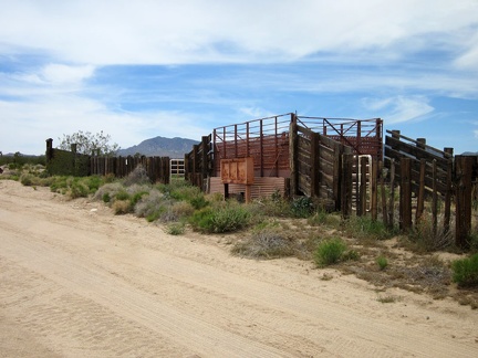 The 10-ton bike takes a break at the junction of New York Mountains Road so I can check out an old OX Ranch corral