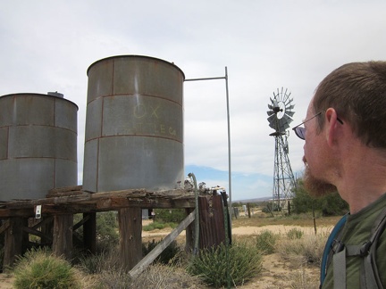 A couple of old water tanks and a windmill sit near Ivanpah Road at the OX Ranch site