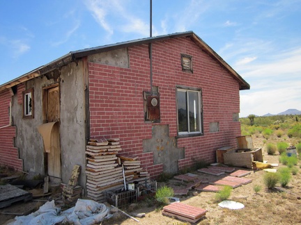 Behind the little house on Cedar Canyon Road, some of the old fake-brick tiles are neatly piled