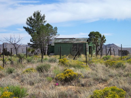 A short distance ahead is another modest old house along Cedar Canyon Road, against a Hackberry Mountains backdrop