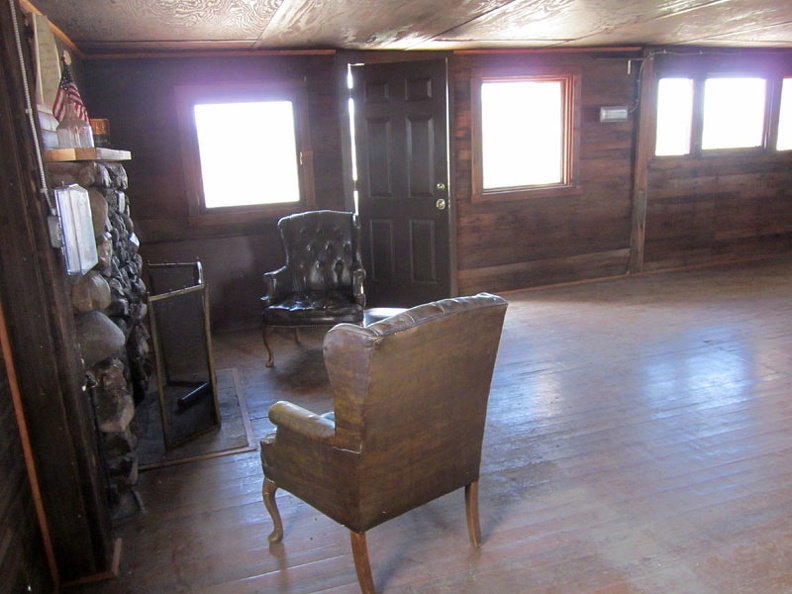 The Bert Smith rock house has a low ceiling and dark-colored surfaces