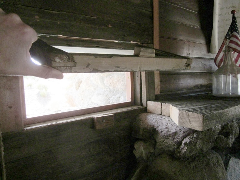 The little windows that flank the fireplace in the Bert Smith rock house are hinged on the top