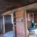 A small kitchen hides behind these built-in shelves; interesting joint in the beam