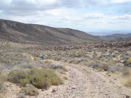 I go for a short walk up to the nearby summit of Gold Valley Road and look back down at the tent