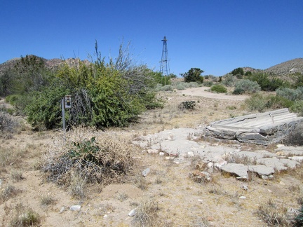 A windmill, a defunct wilderness camera and a dry cistern all sit at the old Lecyr Well site, Mojave National Preserve