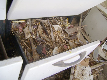 The other bottom drawer of the stove is full of packrat materials