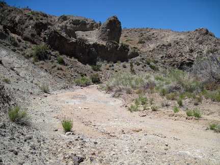 A rock outcrops juts out from the wall of Malpais Spring wash like an arrowhead
