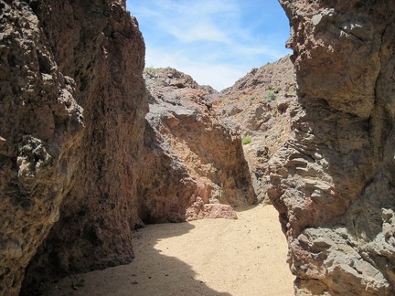 Deposits of sand and silt fill the drainage between the rocks
