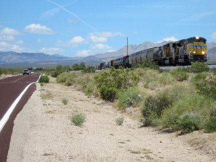 One of several long freight trains passes by as I slowly rise up Kelso-Cima Road