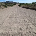 Looking behind me at the heavily washboarded surface of Cedar Canyon Road as it drops into Cedar Wash