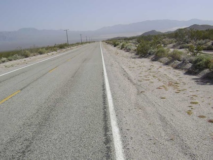 Kelbaker Road drops down toward Kelso and the sand piles of the Kelso Dunes become visible in the distance down in the valley