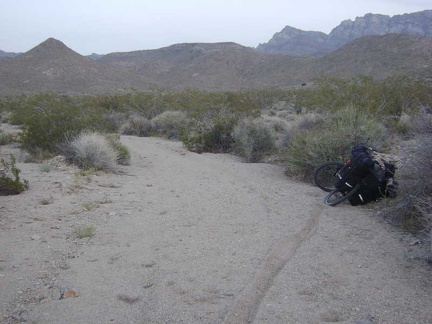 I follow tire tracks up a wash that seems to be the middle fork of Globe Mine Road and drag the bike through the deep sand