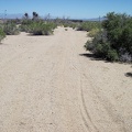 I ride through the sandy area at the end of the road and arrive at the train tracks in Ivanpah Valley