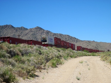 I start riding up lonesome Brant Road toward Cima, my next stop, and a train passes