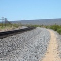 Brant Road hugs the train track as it curves to follow the route toward Cima, Mojave National Preserve