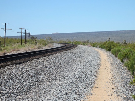 Brant Road hugs the train track as it curves to follow the route toward Cima, Mojave National Preserve