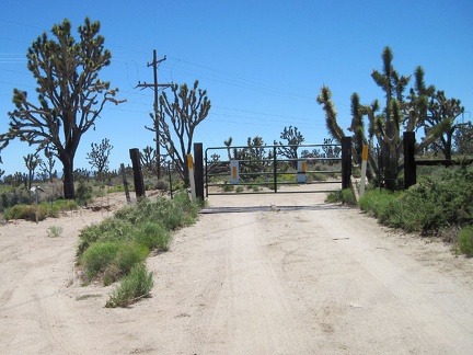 I start riding up the powerline road, pass an electrical substation, then reach a closed gate